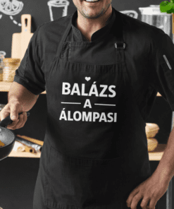 Fakanalas szakács fekete kötény, balázs a álompasi felirattal, modern konyha háttérrel.