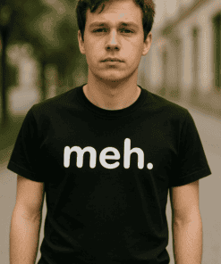 Férfi fiatalember utcai környezetben, fekete "meh." feliratú pólóval.